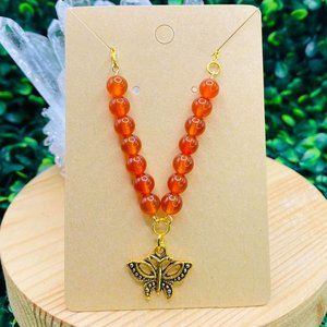 Carnelian crystal gold necklace with butterfly pendant.